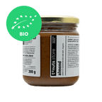 300g glass jar of almond paste with a visible label and organic certification logo on a black background