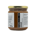 300g glass jar of almond paste with a label on a black background
