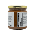 300g glass jar of almond paste with a label on a black background
