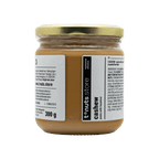 300g glass jar of cashew paste with a label on a black background