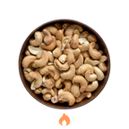 Bowl of roasted cashews on a white background