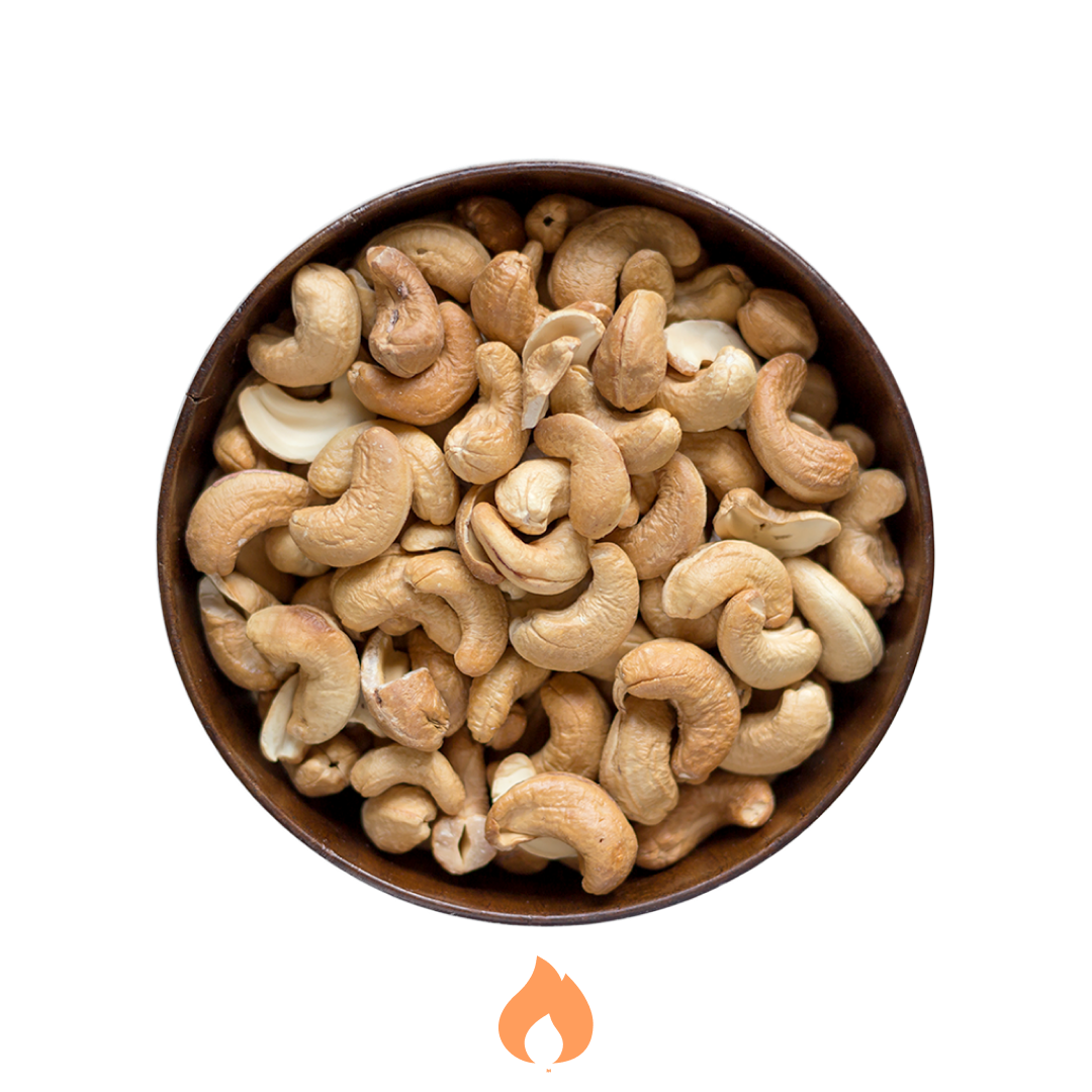 Bowl of roasted cashews on a white background
