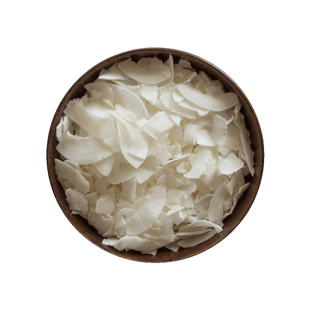 Brown bowl filled with white coconut chips on a black background