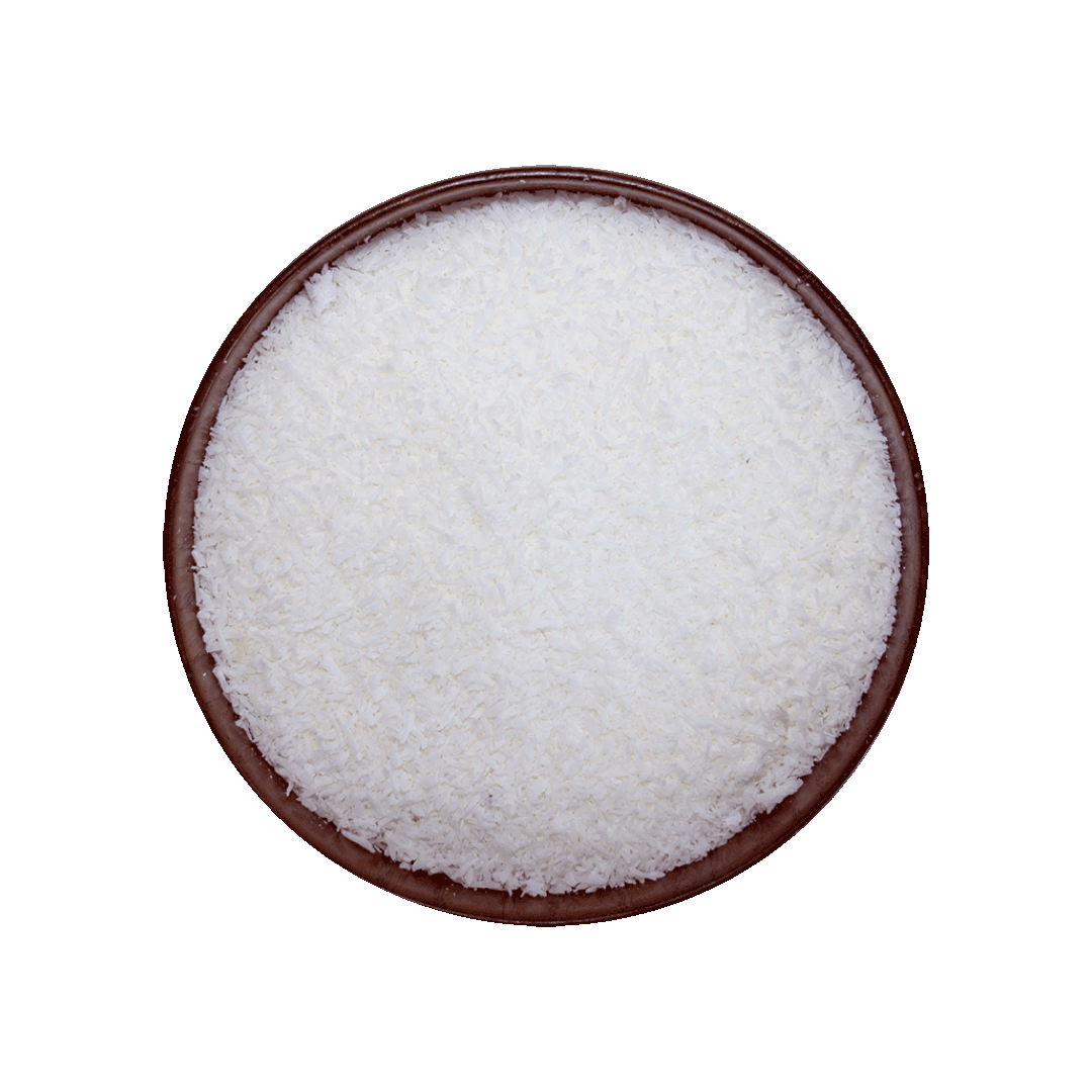 Brown bowl filled with grated coconuts on a black background