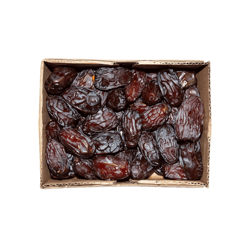 Box of dried dates on a black background