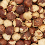 Close-up of a pile of hazelnuts with a mix of brown and beige colors.
