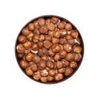 Round bowl filled with hazelnuts on a black background