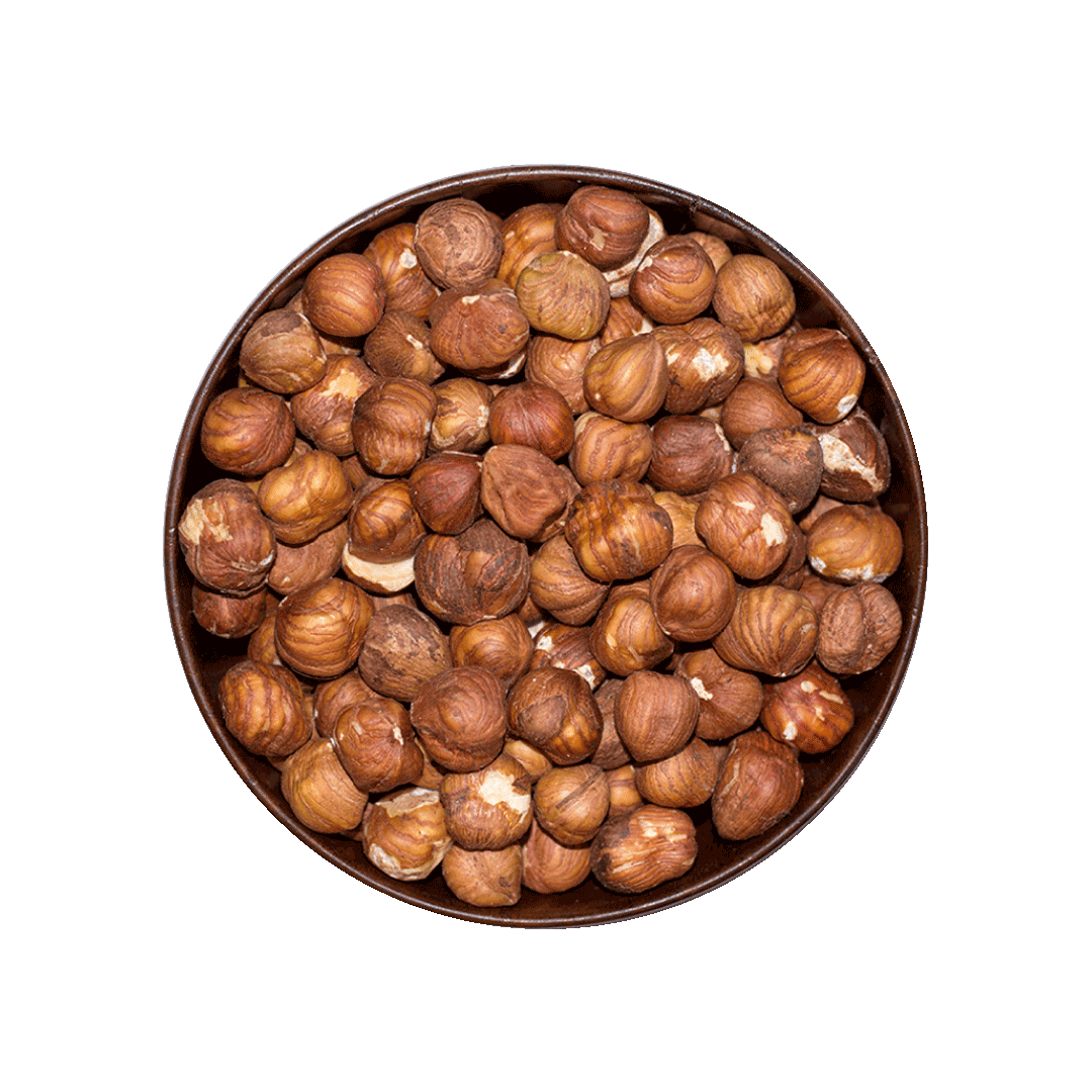 Round bowl filled with hazelnuts on a black background