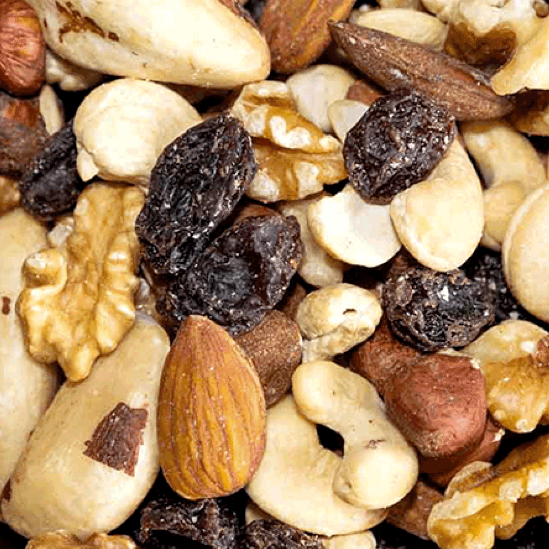 Close-up of a mixed nut blend including almonds, walnuts, brasil nuts, cashew and raisins.