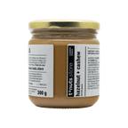 300g glass jar of hazelnut and cashew spread with a visible label on a black background