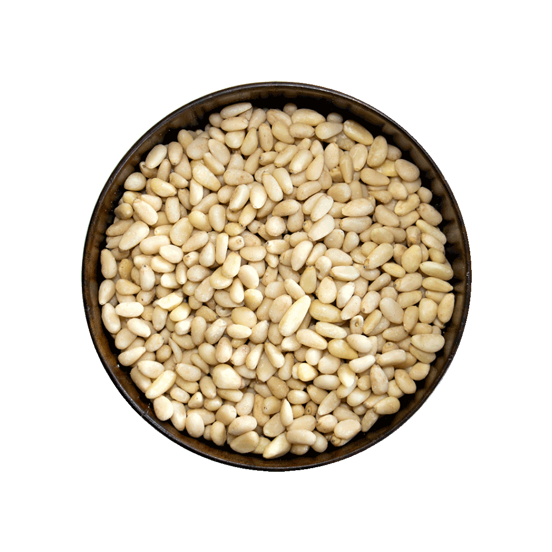 Pine nuts in a metal bowl on a black background