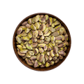 Pistachios in a brown bowl on a black background