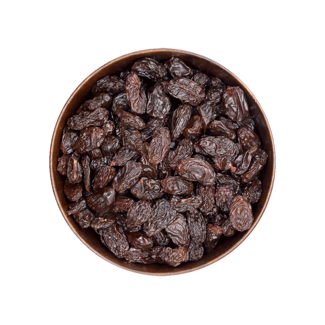 Bowl of raisins on a black background