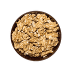 Pile of walnuts in a bowl on a black background