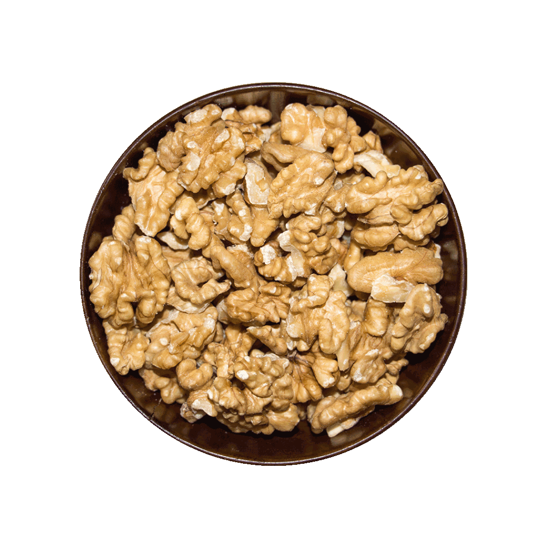 Pile of walnuts in a bowl on a black background