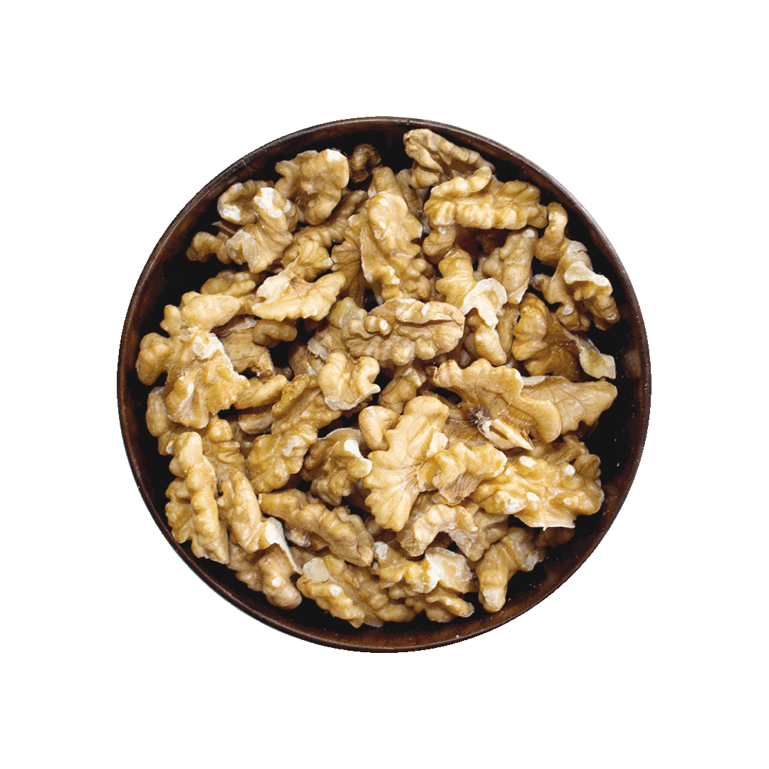Walnuts in a wooden bowl on a black background